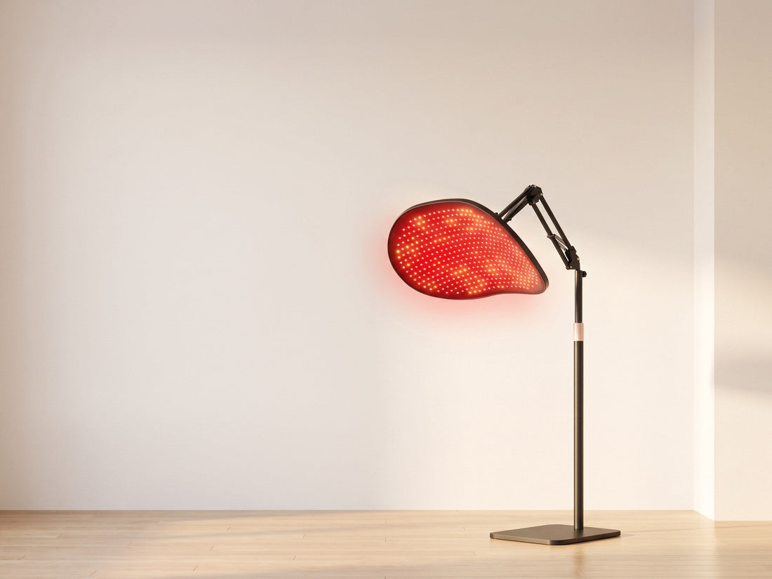 A red light therapy panel with adjustable stand against a bright porcelain backdrop